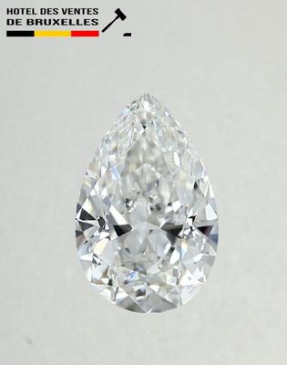 a close up of a pear shaped diamond on a white surface