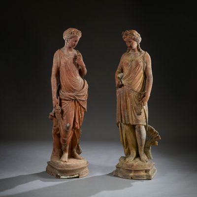 two statues of a man and a woman standing next to each other