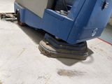 a blue machine that is sitting on the ground