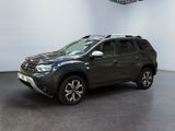 the grey dacia is parked in a large room with a ceiling fan