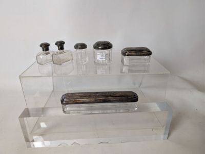 clear acrylic display case with three bottles and a soap dispenser