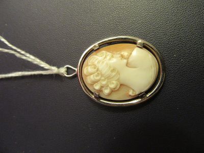 a picture of a necklace with a picture of a woman on it