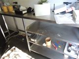 a metal table with a bunch of items on top of it