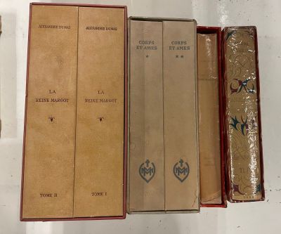 several books are lined up in a row on a table