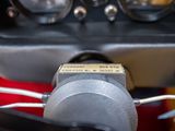a close up of a car dashboard with gauges and wires