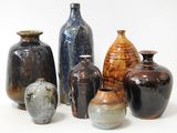 many different vases that are sitting on a white surface