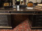 a desk with a mirror and a book on top of it