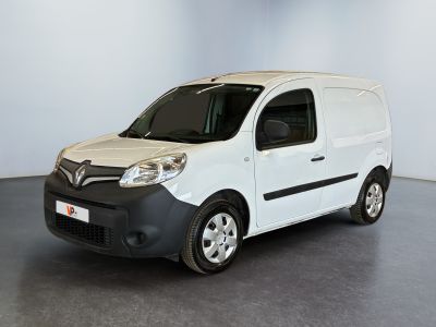 the small white van is parked in a large room