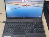 dell laptop with keyboard and mouse sitting on a desk in front of a monitor