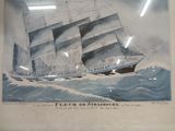 painting of a ship in a frame on a wall in a room