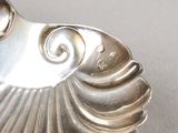 a close up of a silver spoon on a table