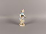 a small figurine of a woman with a basket of flowers