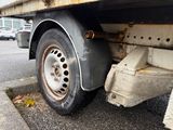 a close up of a flatbed truck with a flat tire