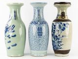 three blue and white vases sitting next to each other on a white surface