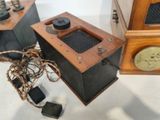 two old fashioned radio ' s sitting on the floor next to each other
