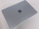 a silver apple laptop sitting on a white table