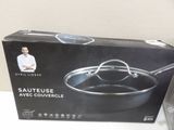packaging of a black cookware box with a picture of a man in a white shirt standing next to it