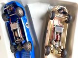 two toy cars that are sitting in a box