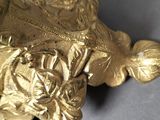 a close up of a gold object on a table