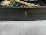 a black box with some food in it and a pair of chopsticks in it