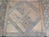 a wooden floor with a tile pattern on it