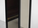 a mirror that is on the floor in front of a wall