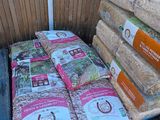 many bags of rice sitting on a cart in the yard
