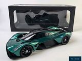 green and black model of a sports car in front of a black box
