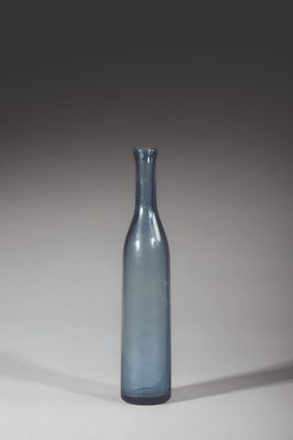 a blue glass bottle that is sitting on a table