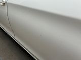 a white car that is parked on the side of the street