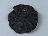 a close up of a small black object on a table