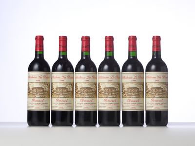four bottles of red wine lined up in a row