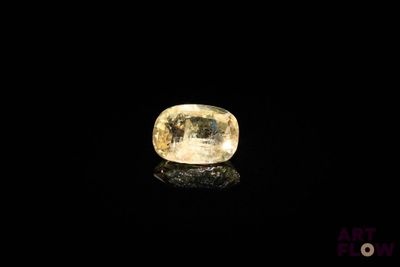 a yellow diamond on a black surface