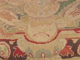 a close up of a rug with many designs on it