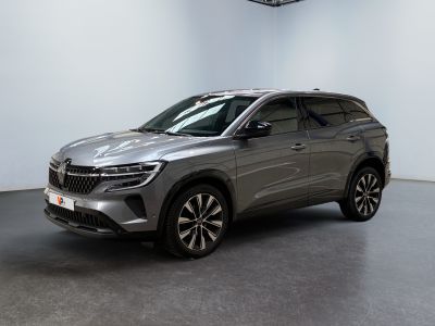 a silver suv is parked in a large room with a ceiling fan
