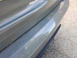 a close up of a car ' s bumper with a cat on it