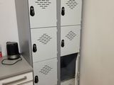 several metal lockers are stacked on top of each other in the corner of a room