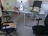 a desk with a chair and a computer on it