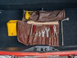 tools in the trunk of a car that is packed with leather