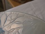 a glass bowl with a design on it on a table