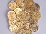 a pile of gold coins sitting on a white surface