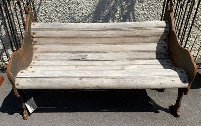 a wooden bench that is sitting in the middle of the street