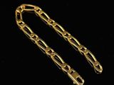 a pair of gold chains on a black background