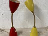 pair of red and yellow table lamps sitting on a white surface