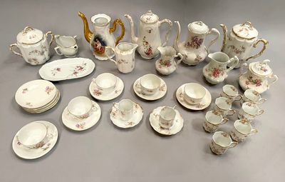 many different types of teapots and saucers on the table
