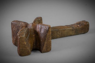 an image of a wooden mallet on a gray background