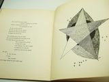 an open book with a drawing of a star on it