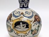 a blue and white vase with a picture of a woman on it