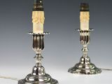 pair of silver plated candlesticks with carved faces