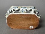 a small wooden box with a blue and white design on it